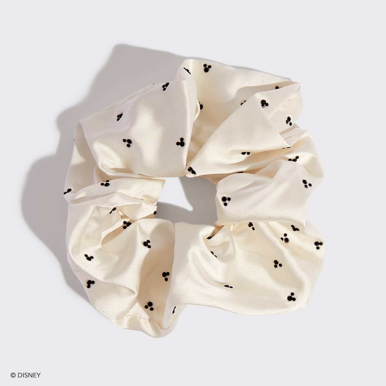Blyskt  Cream-colored scrunchie with black mickey mouse dots on a light gray background