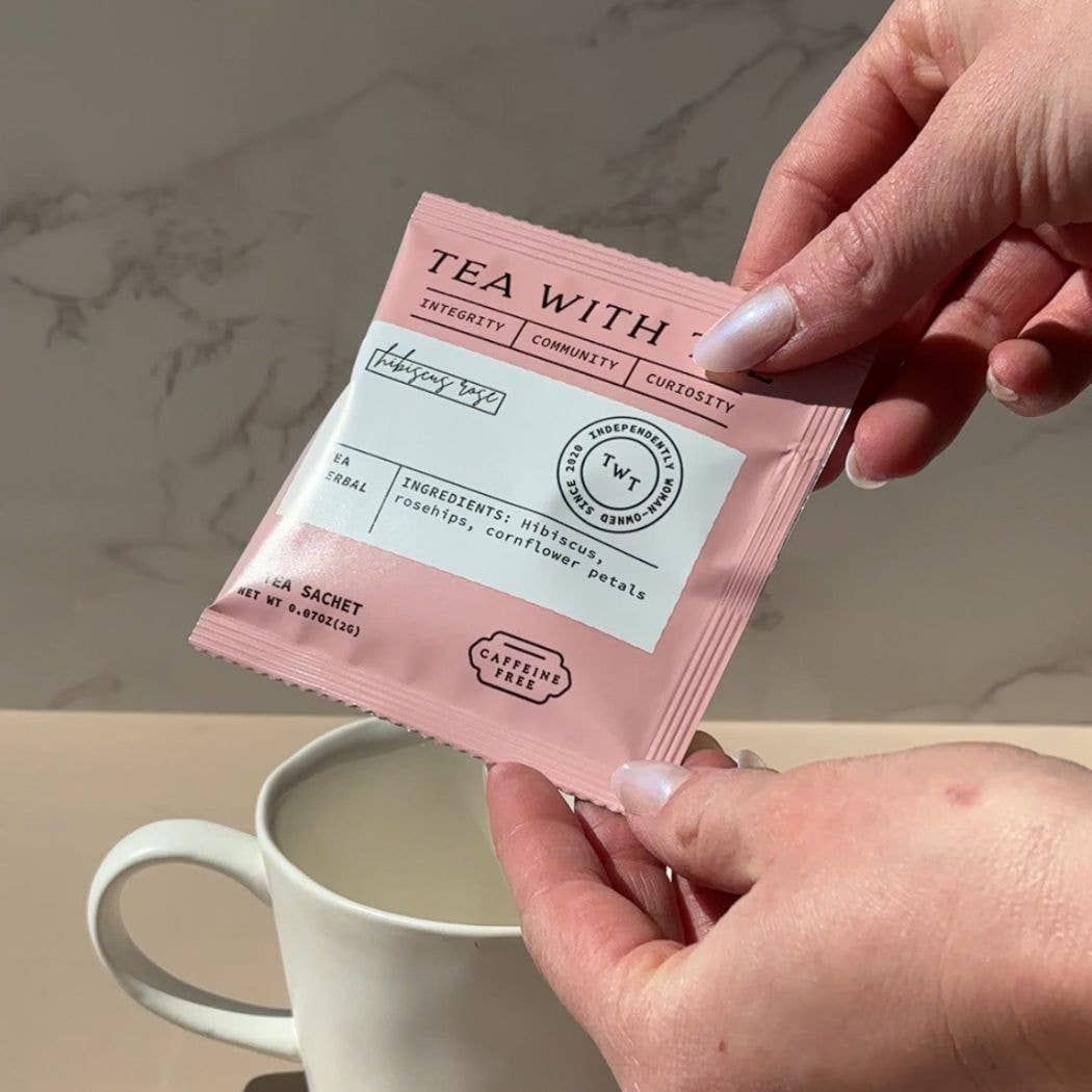 Blyskt Person holding a 'Tea with' package with a cup of tea in the background