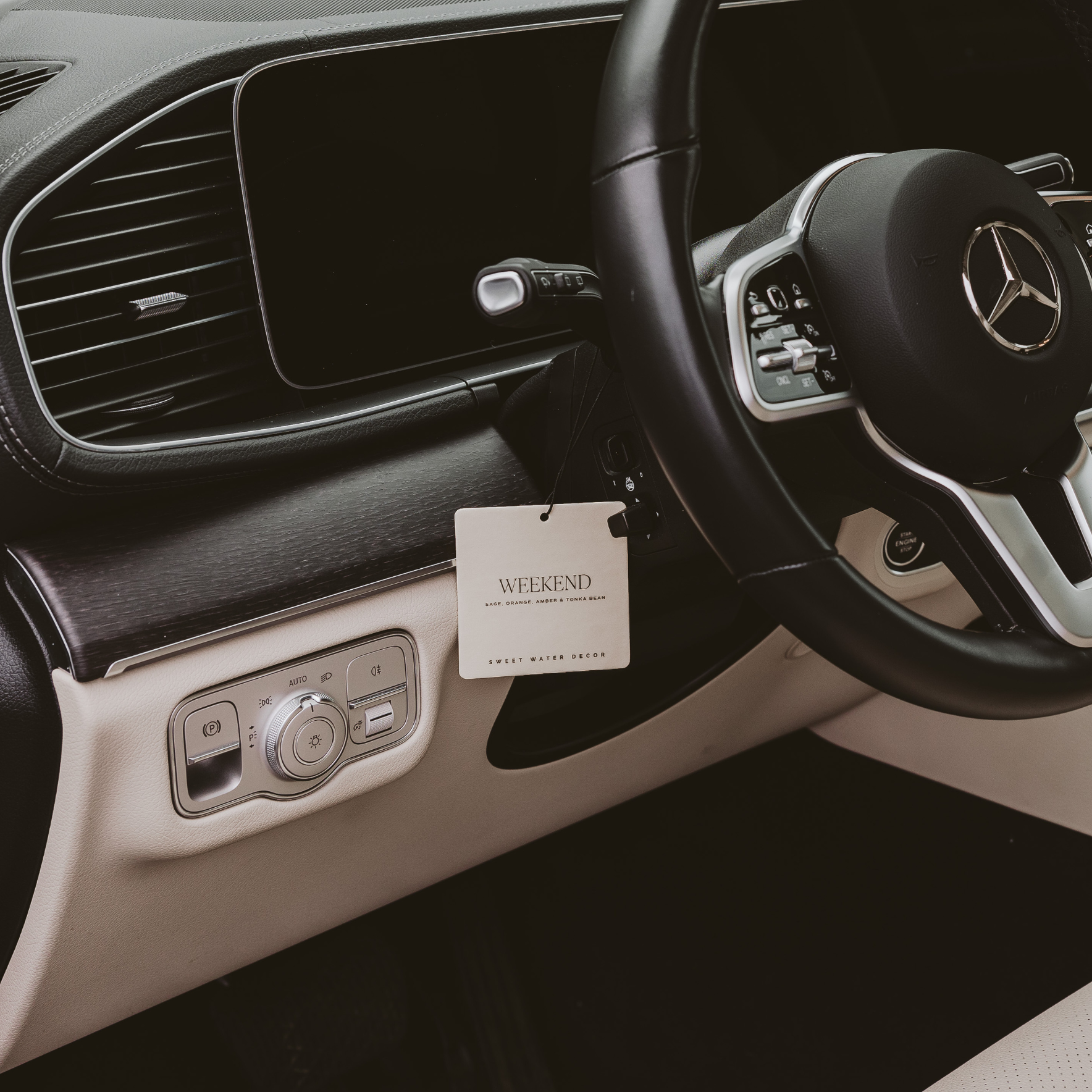 Blyskt Car interior with steering wheel and dashboard, featuring a 'Weekend' tag.