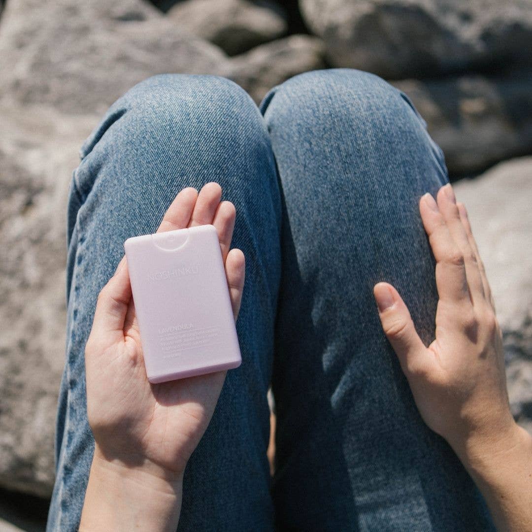Blyskt Person holding a pink rectangular object against a rocky background