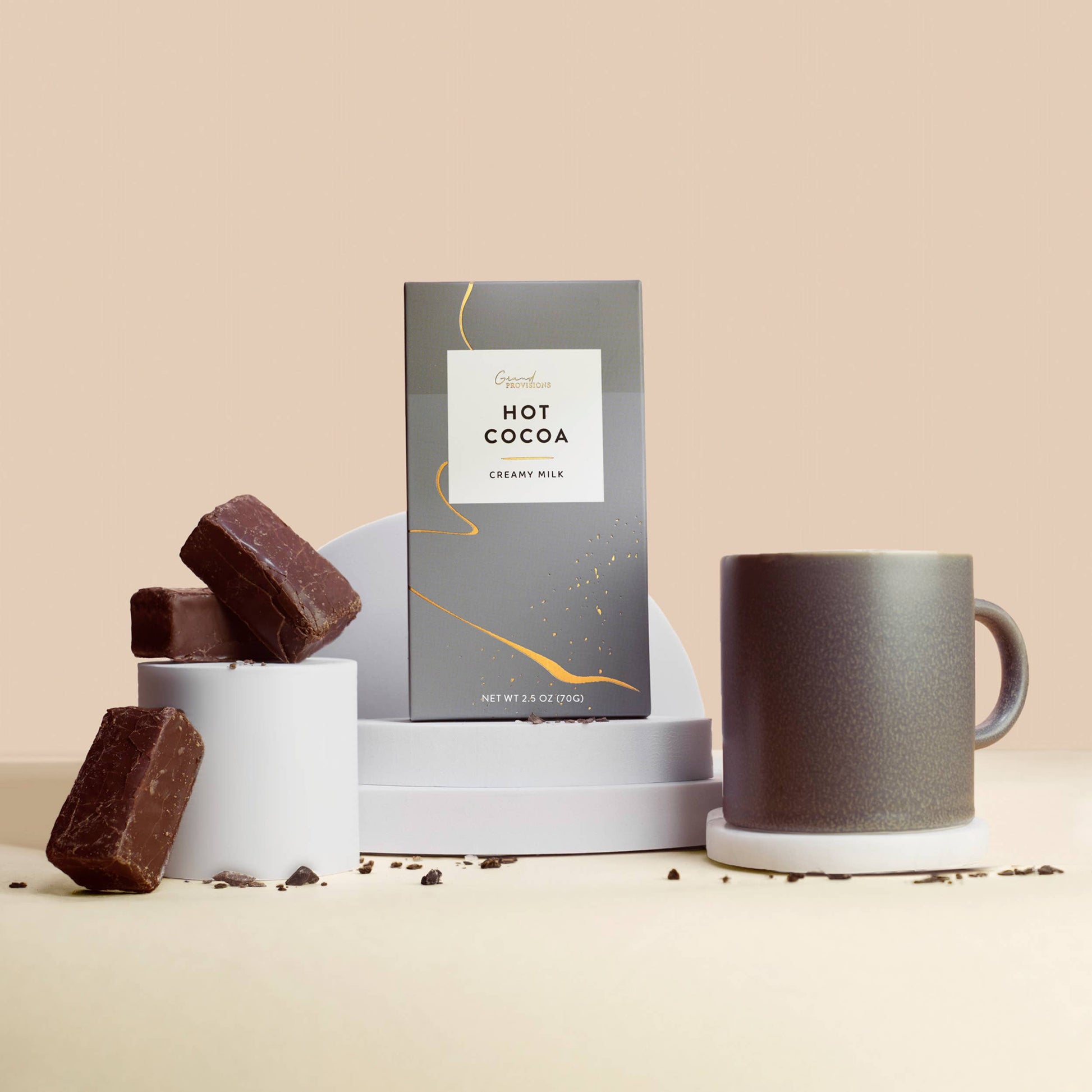 Blyskt Hot cocoa package with chocolate pieces and a mug on a beige background