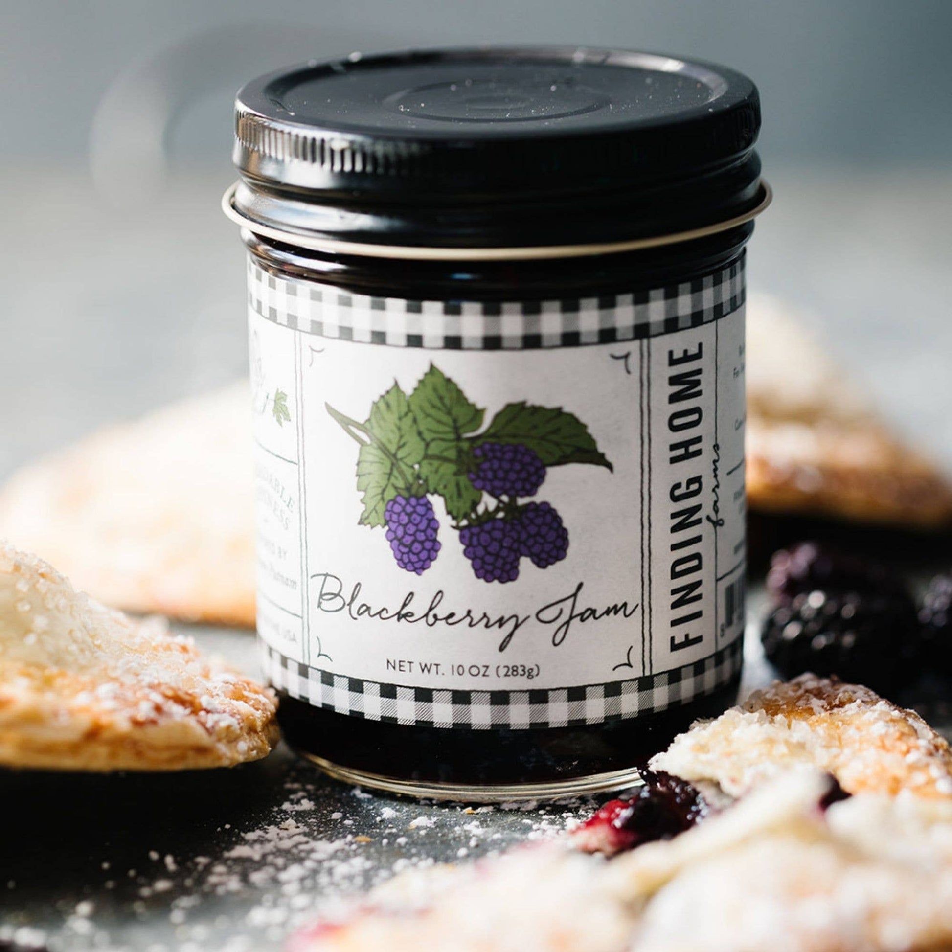 Blyskt Jar of Finding Home Blackberry Jam with a pie in the background