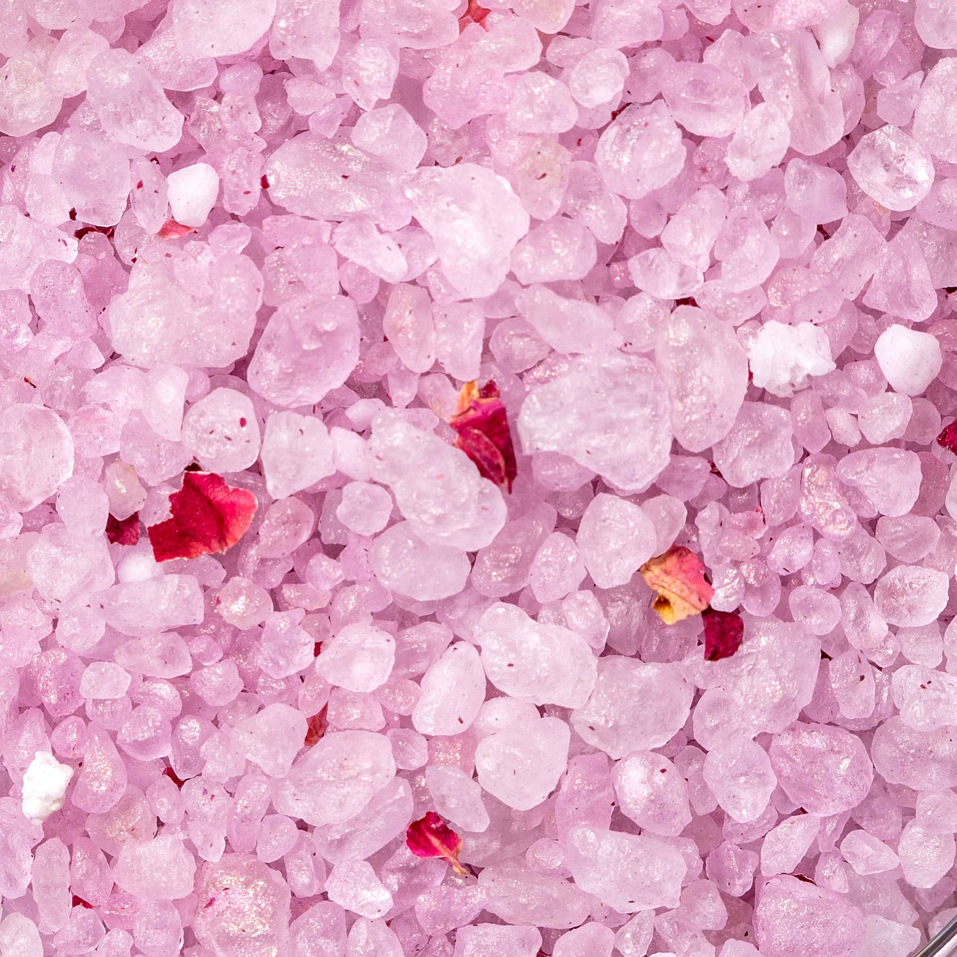 Close-up of pink bath salts with small red rose petals, luxury gift for Orlando gifting by Blyskt